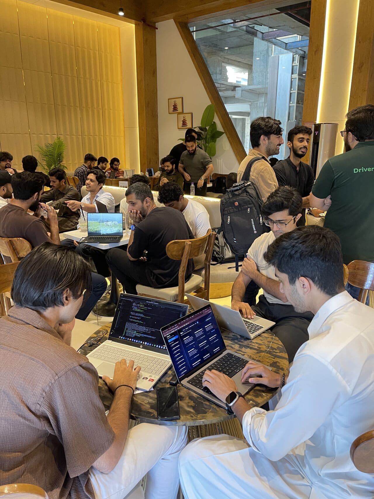 Cursor event participants gathered around laptops